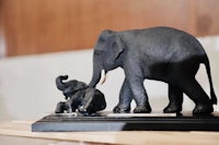 a statue of an elephant and a baby on a table