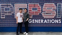 two men standing in front of a pepsi generations sign