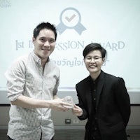 a man and a woman standing next to each other holding an award