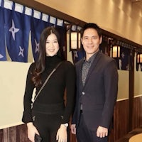 a man and woman posing for a picture in a restaurant