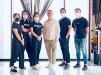 a group of people standing in front of a window