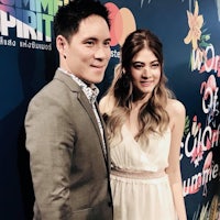 a man and woman standing next to each other at an event