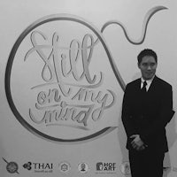 a man in a suit standing next to a sign that says still on my mind