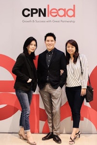 three people standing in front of a sign that says cpn lead