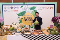 a man standing in front of a table full of food