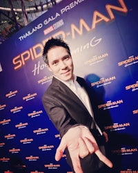 a man in a suit is posing for a picture at the spider - man premiere